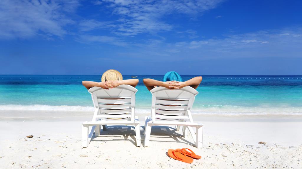 Couple in deckchairs on beach