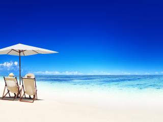 Couple Relaxing in Deck Chairs Beach